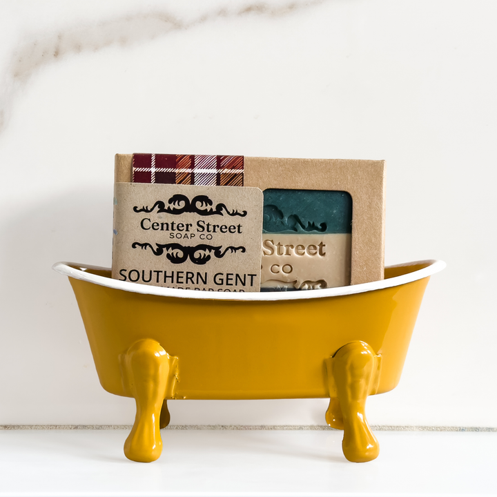 Southern Gent Handmade Soap Bar by Center Street Soap Co. in a mustard yellow bathtub soap dish